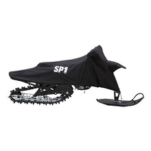 A black SPX branded snow bike cover fitted on a motorcycle with visible tracks on the ground.