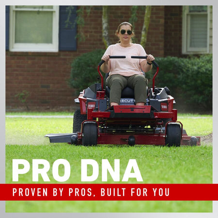 Person operating a red riding lawn mower with 'Pro DNA' branding text.