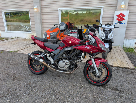 Red 2007 Suzuki SV650S ABS, left side, parked in front of Garage Harry Stanley
