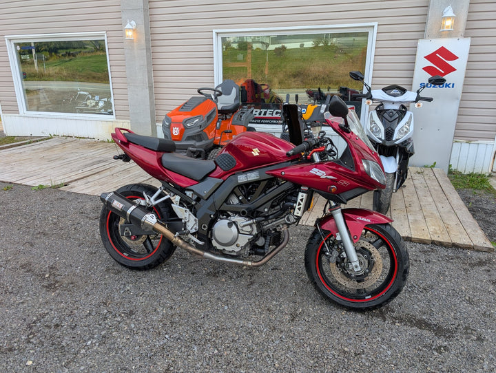 Red 2007 Suzuki SV650S ABS, left side, parked in front of Garage Harry Stanley