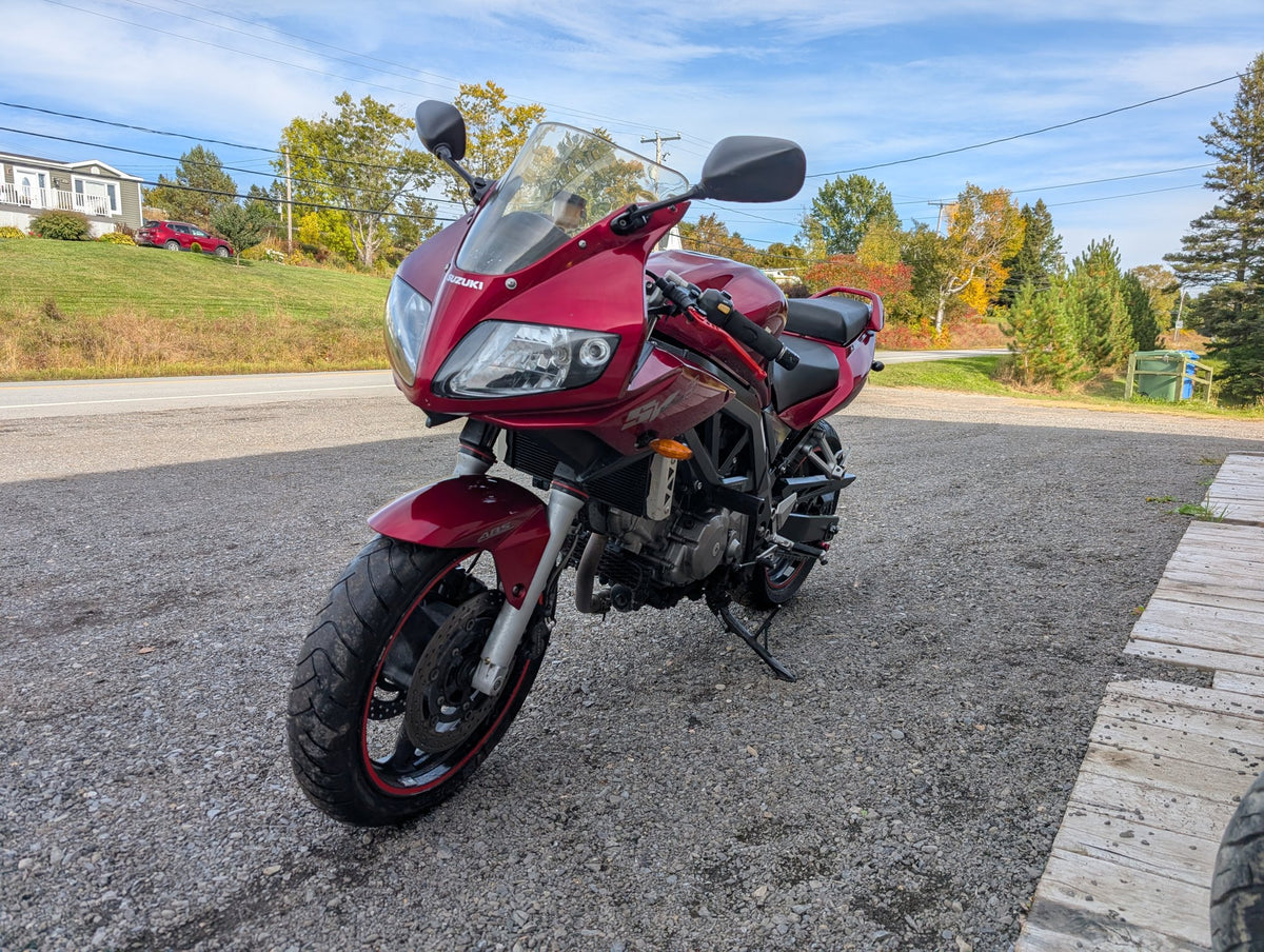 Front three-quarter view of the red 2007 Suzuki SV650S with half fairing and windscreen