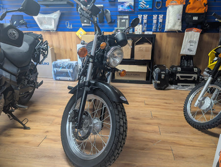 Front view of the 2018 Suzuki VanVan 200 with chrome headlight and wide front tire
